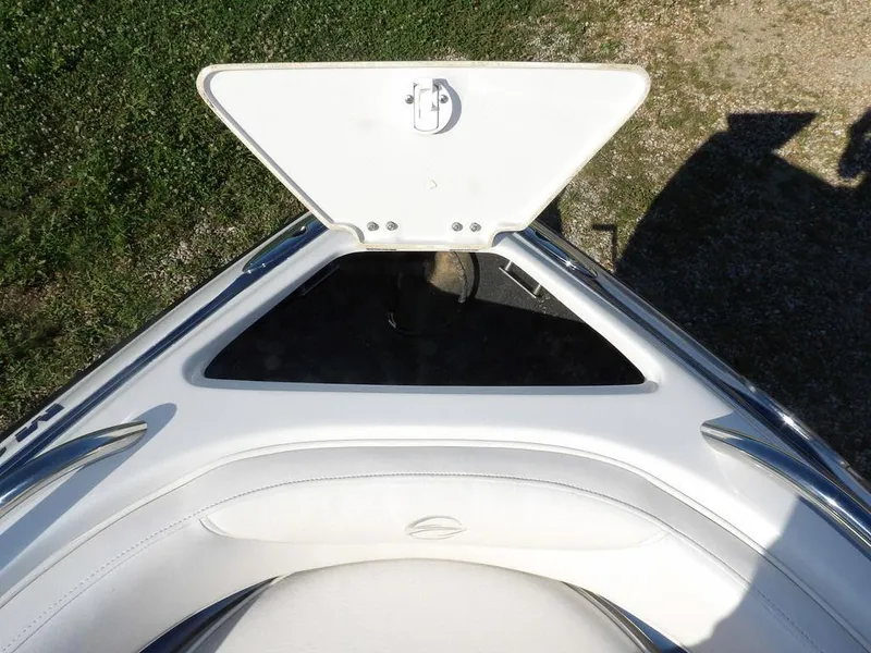 Slide: The Image of Bow storage compartment of a 2004 Crownline 202BR boat, open on grassy ground. - 29