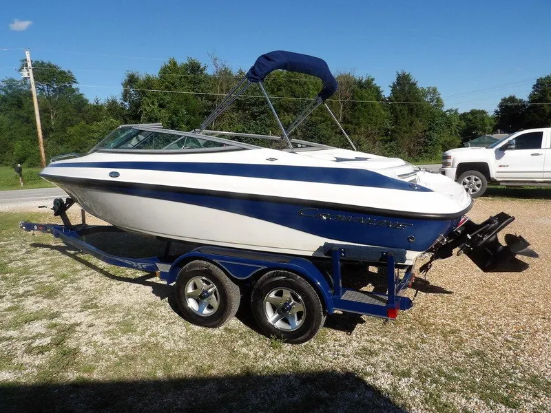 Slide: The Image of 2004 Crownline 202BR boat on trailer, parked outdoors on a sunny day. - 3