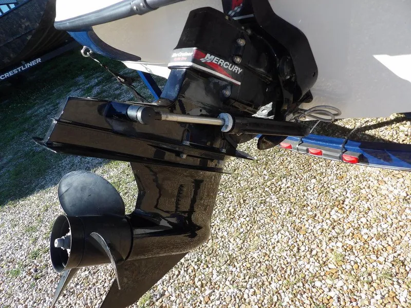 Slide: The Image of 2004 Crownline 202BR boat with Mercury outboard motor on gravel surface. - 38