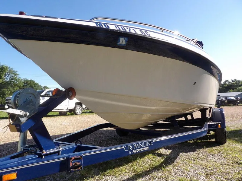 Slide: The Image of 2004 Crownline 202BR boat on trailer, parked outdoors under clear blue sky. - 40