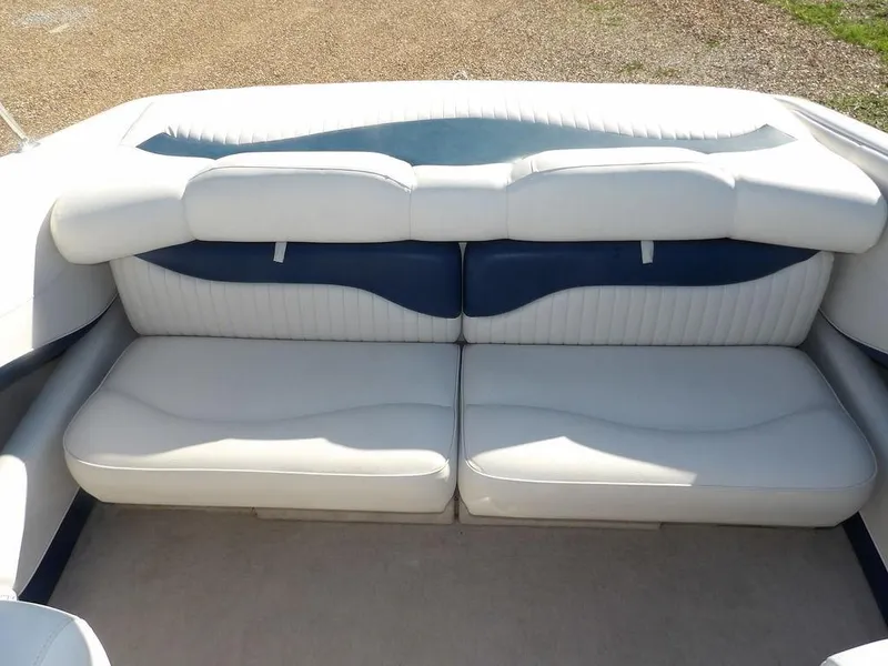 Slide: The Image of 2004 Crownline 202BR boat interior seating with white and blue upholstery. - 9