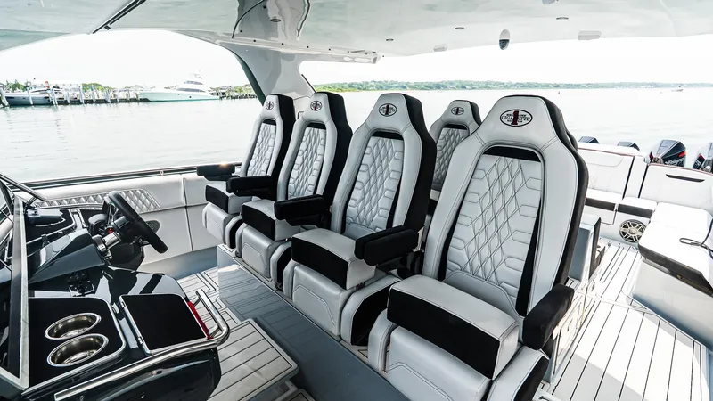Slide: The Image of Luxury interior of 2025 Cigarette 52 Thunder boat with plush seating and sleek design. - 21