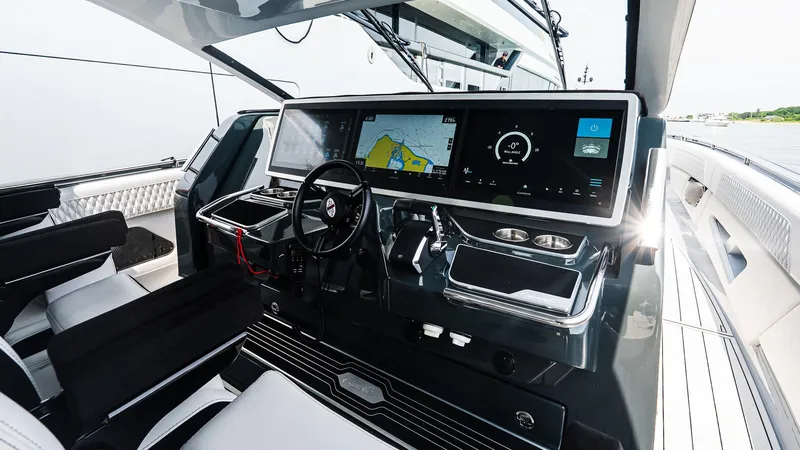 Slide: The Image of Helm of 2025 Cigarette 52 Thunder yacht with advanced navigation displays and controls. - 28