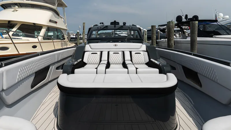 Slide: The Image of Luxury 2025 Cigarette 52 Thunder yacht interior with plush seating at a marina. - 34