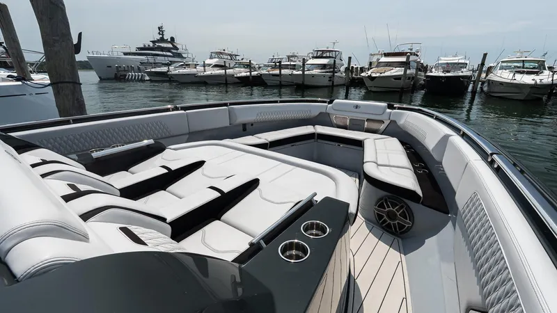 Slide: The Image of Luxurious 2025 Cigarette 52 Thunder yacht interior with plush seating, docked among other boats. - 35