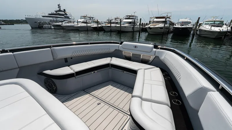 Slide: The Image of Luxurious 2025 Cigarette 52 Thunder boat interior with sleek seating, docked near yachts. - 38