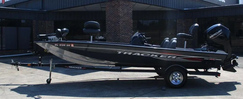 The Image of 2021 Tracker Pro Team™ 190 TX fishing boat on trailer, parked outdoors. - 1
