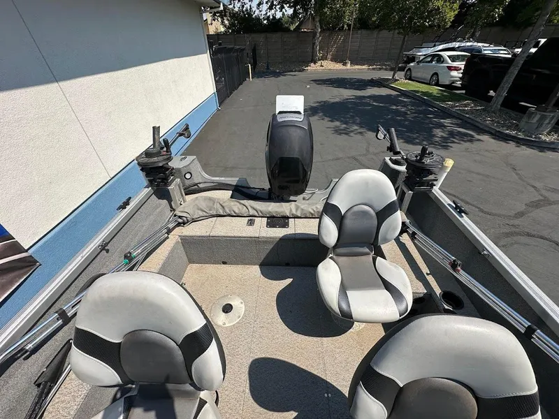 Slide: The Image of 2015 Alumacraft Competitor 165 Sport boat interior with seating and fishing rod holders. - 10