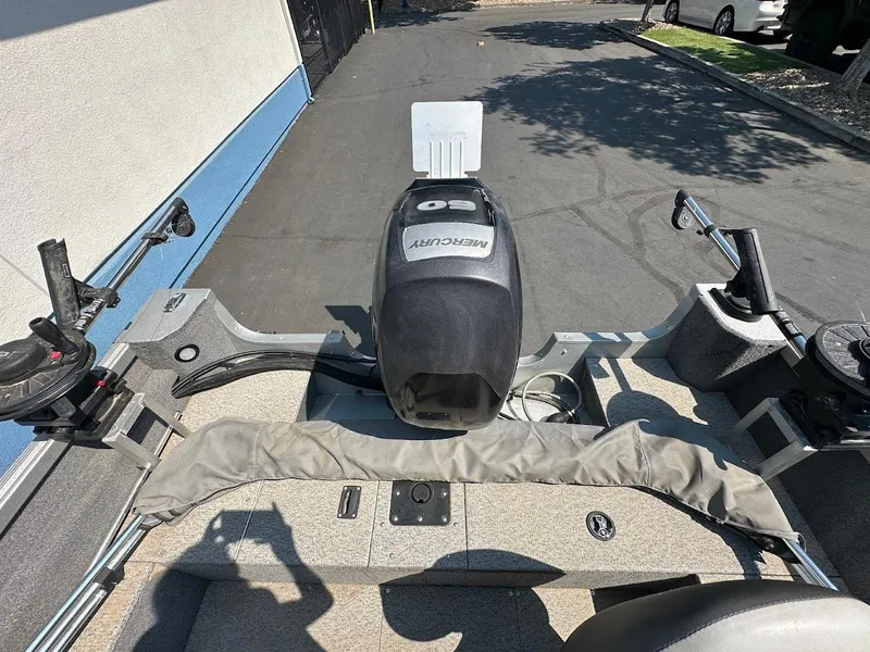 Slide: The Image of 2015 Alumacraft Competitor 165 Sport boat with Mercury engine, parked on pavement. - 11