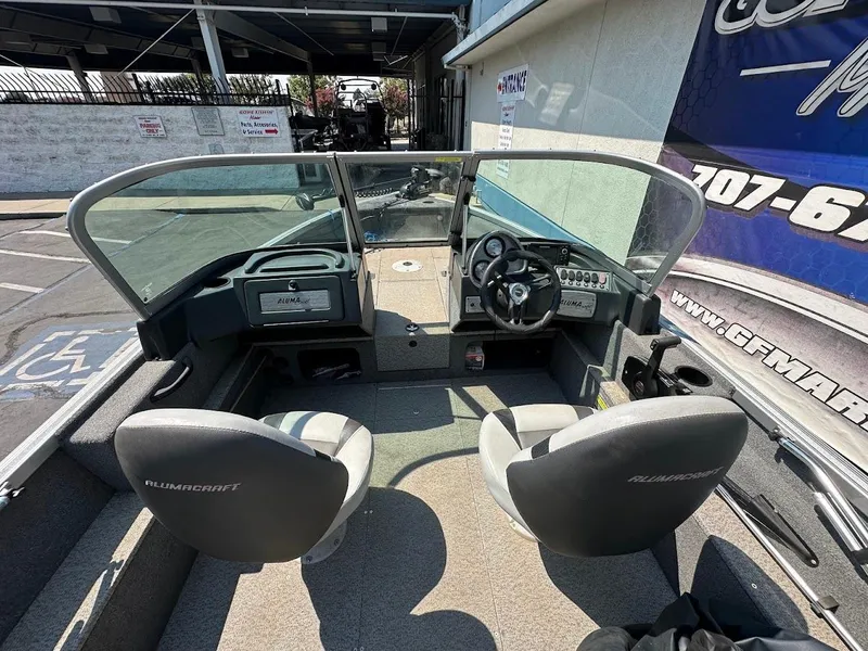 Slide: The Image of 2015 Alumacraft Competitor 165 Sport boat interior with dual seats and steering console. - 12