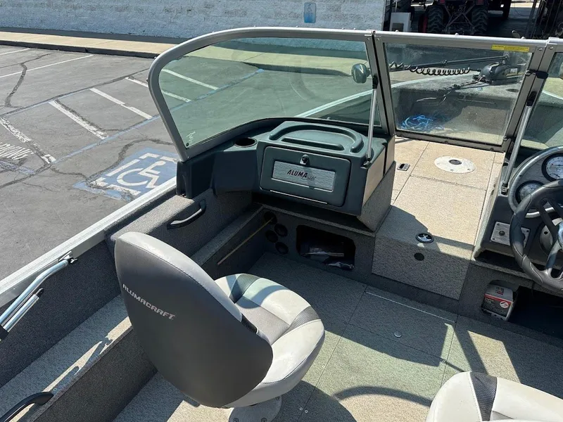 Slide: The Image of 2015 Alumacraft Competitor 165 Sport boat interior with seating and dashboard. - 13