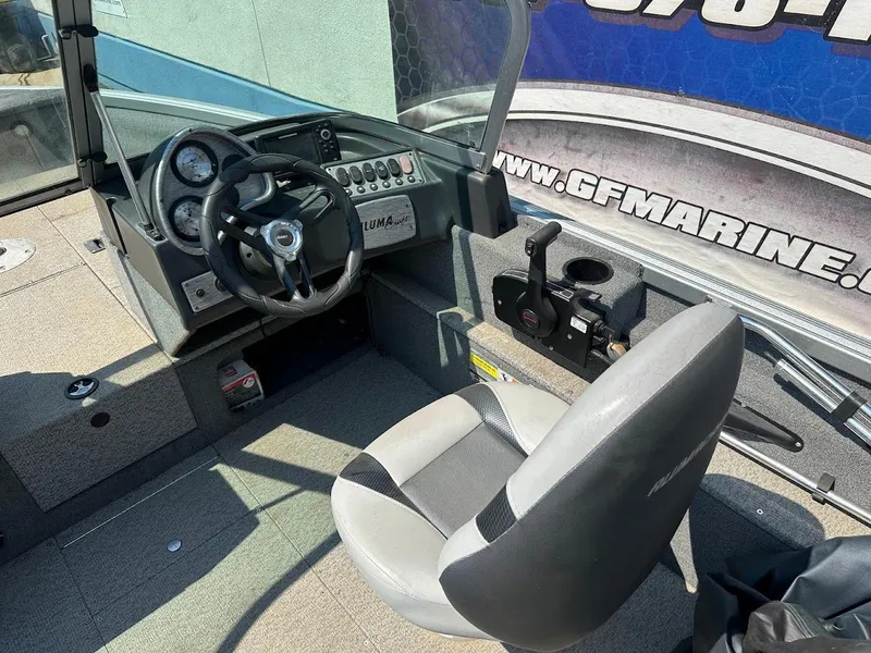 Slide: The Image of 2015 Alumacraft Competitor 165 Sport boat interior with steering wheel and control panel. - 14
