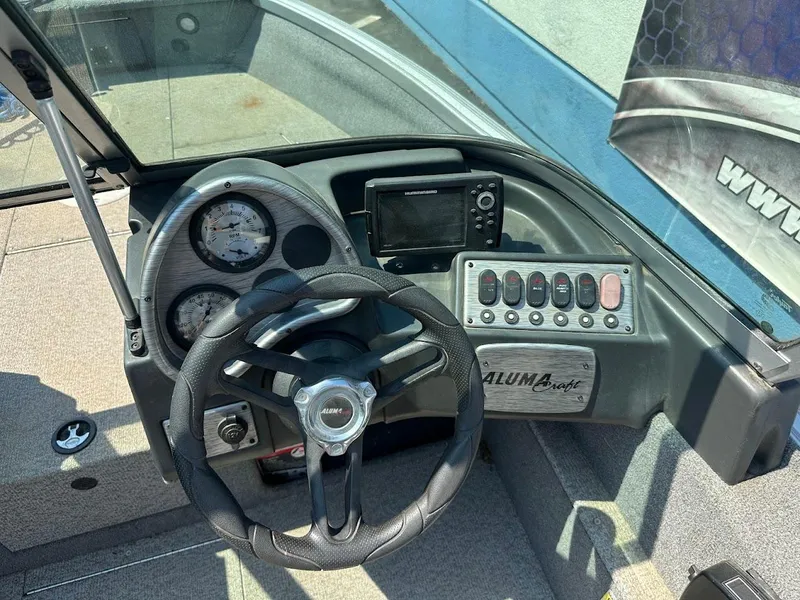 Slide: The Image of 2015 Alumacraft Competitor 165 Sport dashboard with steering wheel and control panel. - 15
