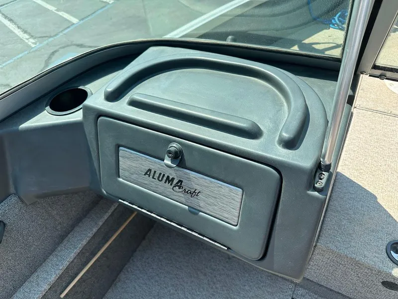 Slide: The Image of 2015 Alumacraft Competitor 165 Sport dashboard with storage compartment and cup holder. - 18