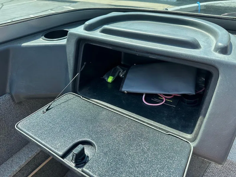 Slide: The Image of Glove compartment of 2015 Alumacraft Competitor 165 Sport boat, containing various items. - 19