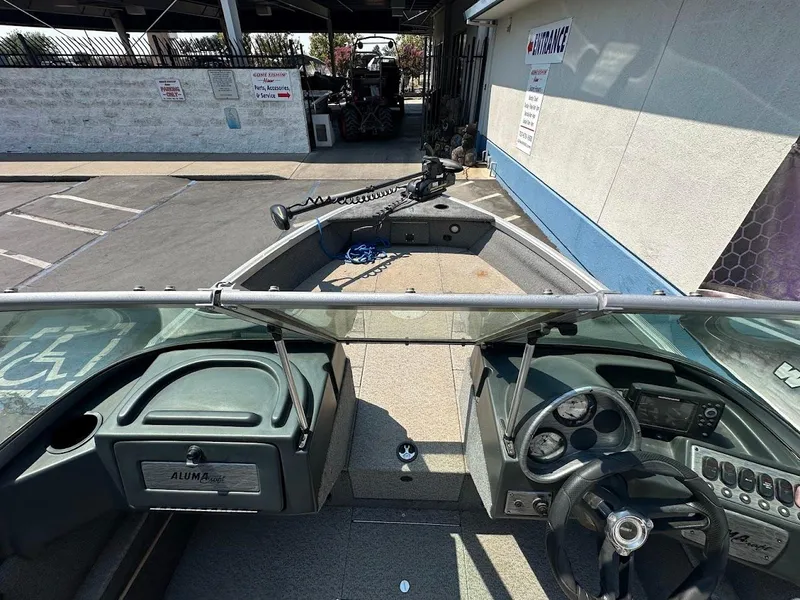 Slide: The Image of 2015 Alumacraft Competitor 165 Sport boat interior with steering wheel and dashboard controls. - 20