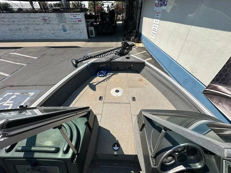 Slide: The Image of 2015 Alumacraft Competitor 165 Sport boat interior with open deck and steering console. - 21