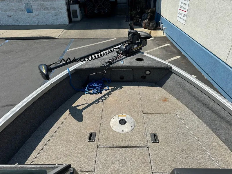 Slide: The Image of 2015 Alumacraft Competitor 165 Sport boat deck with trolling motor and storage compartments. - 22