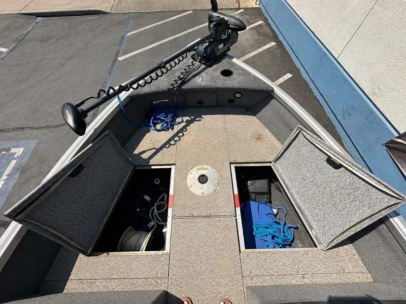 Slide: The Image of 2015 Alumacraft Competitor 165 Sport boat deck with open storage compartments. - 28