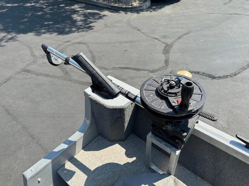 Slide: The Image of 2015 Alumacraft Competitor 165 Sport boat with fishing rod holder and reel setup. - 32