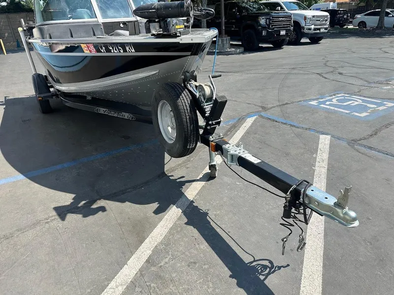 Slide: The Image of 2015 Alumacraft Competitor 165 Sport boat on trailer in parking lot. - 4