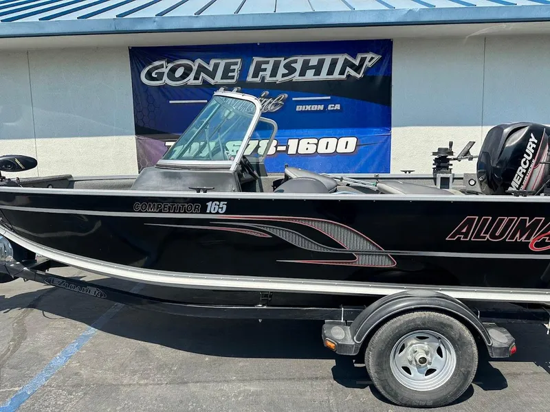 Slide: The Image of 2015 Alumacraft Competitor 165 Sport boat on trailer, displayed outdoors. - 6