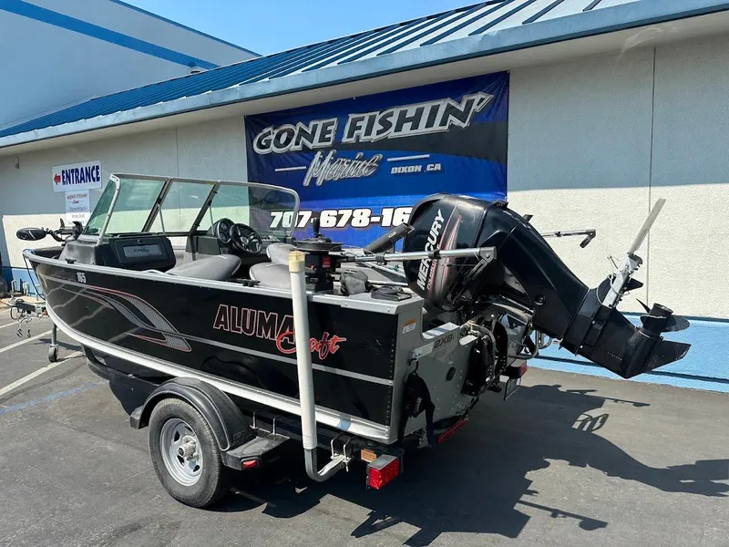 Slide: The Image of 2015 Alumacraft Competitor 165 Sport boat with Mercury outboard motor at dealership. - 7