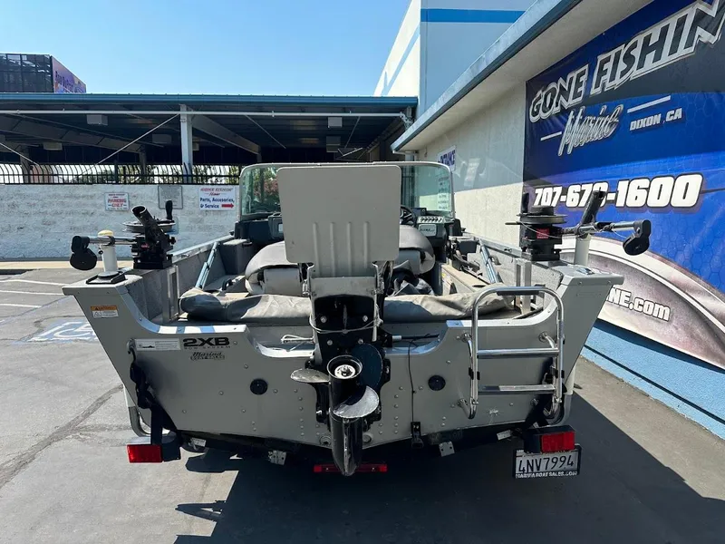 Slide: The Image of 2015 Alumacraft Competitor 165 Sport boat parked at a dealership. - 8