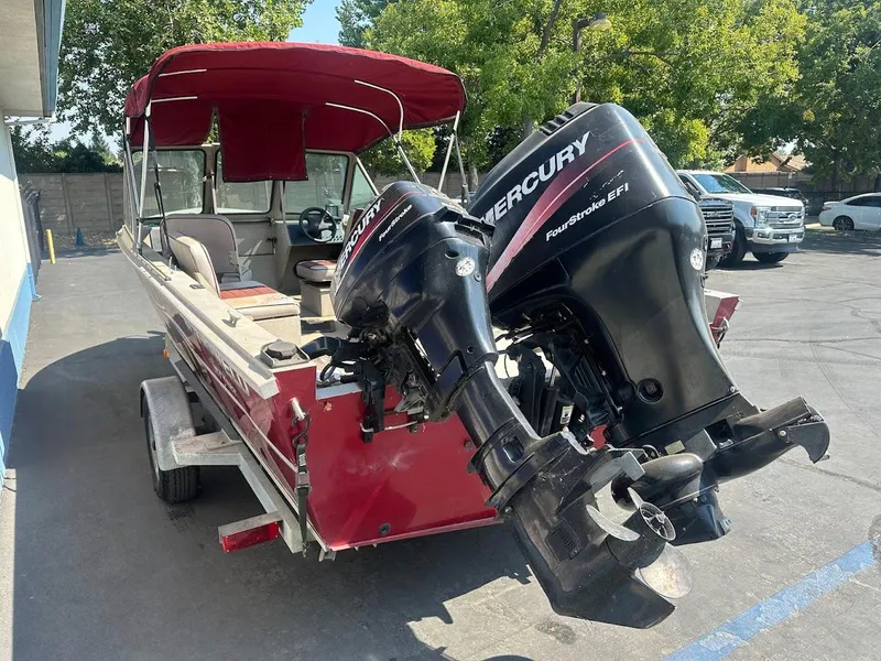 Slide: The Image of 2003 Alumaweld Stryker boat with Mercury outboard motors, parked outdoors. - 10