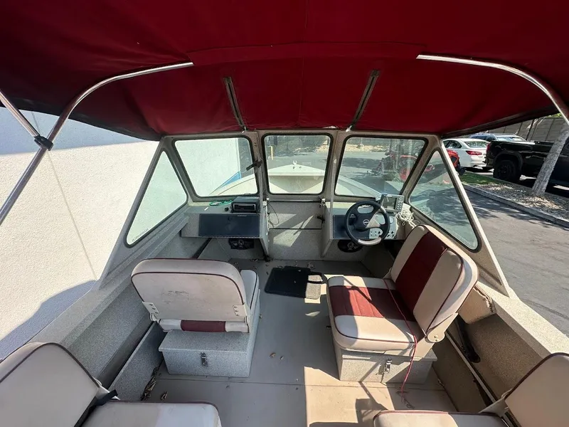 Slide: The Image of 2003 Alumaweld Stryker boat interior with red canopy and seating. - 14