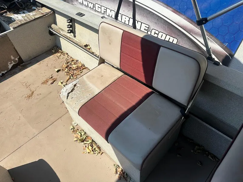 Slide: The Image of Worn seating on 2003 Alumaweld Stryker boat, surrounded by fallen leaves and debris. - 21