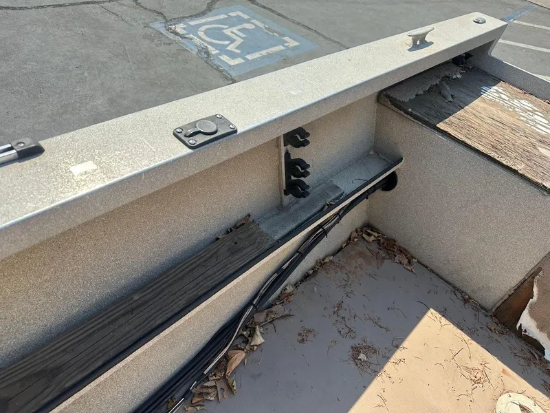 Slide: The Image of 2003 Alumaweld Stryker boat interior with storage compartments and weathered flooring. - 23