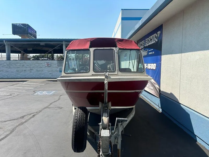 Slide: The Image of 2003 Alumaweld Stryker boat on trailer, parked outside a building. - 3