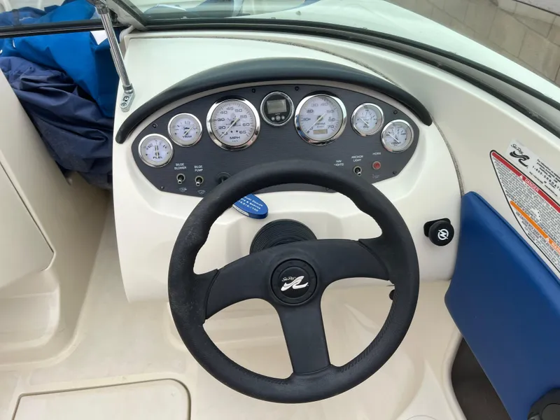 Slide: The Image of Dashboard of a 2007 Sea Ray 185 Sport boat with steering wheel and gauges. - 10