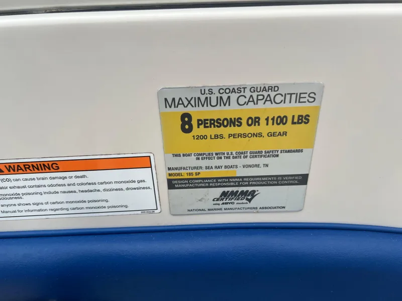 Slide: The Image of 2007 Sea Ray 185 Sport capacity label, 8 persons or 1100 lbs, safety warning included. - 12