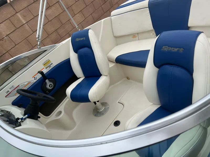 Slide: The Image of 2007 Sea Ray 185 Sport boat interior with blue and white seating. - 7