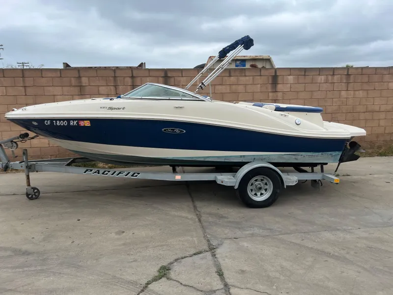Slide: The Image of 2007 Sea Ray 185 Sport boat on trailer, parked outdoors against brick wall. - 8