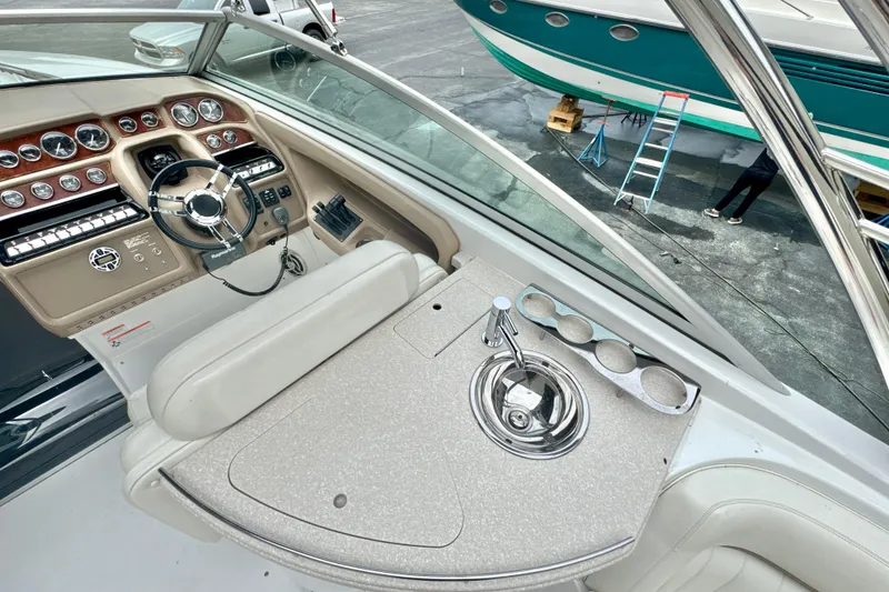 Slide: The Image of 2008 Cobalt 323 boat interior with steering wheel, dashboard, and sink area. - 11