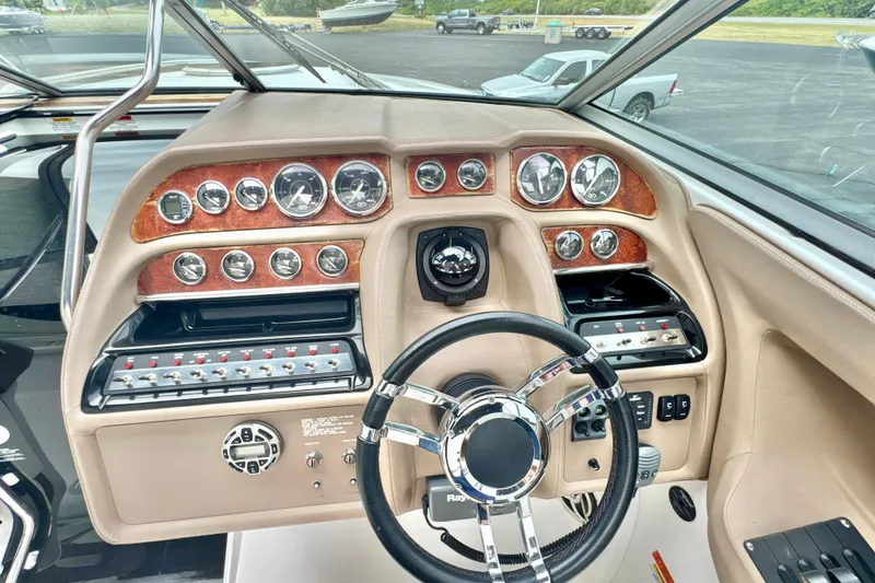 Slide: The Image of 2008 Cobalt 323 boat dashboard with gauges, steering wheel, and control panels. - 14