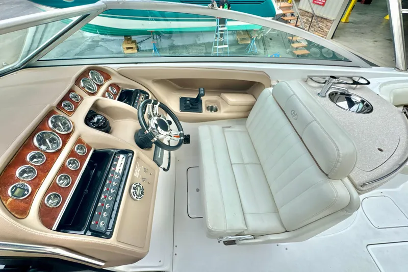 Slide: The Image of 2008 Cobalt 323 boat interior with dashboard, steering wheel, and white seating. - 15