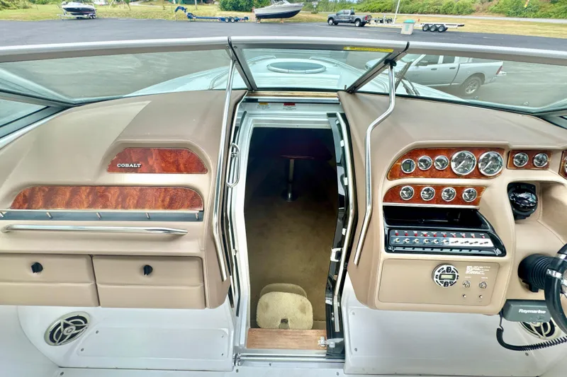 Slide: The Image of 2008 Cobalt 323 boat dashboard with wood accents and control panel. - 17
