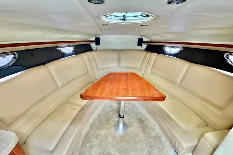Slide: The Image of Luxurious interior of 2008 Cobalt 323 boat with beige seating and wooden table. - 20