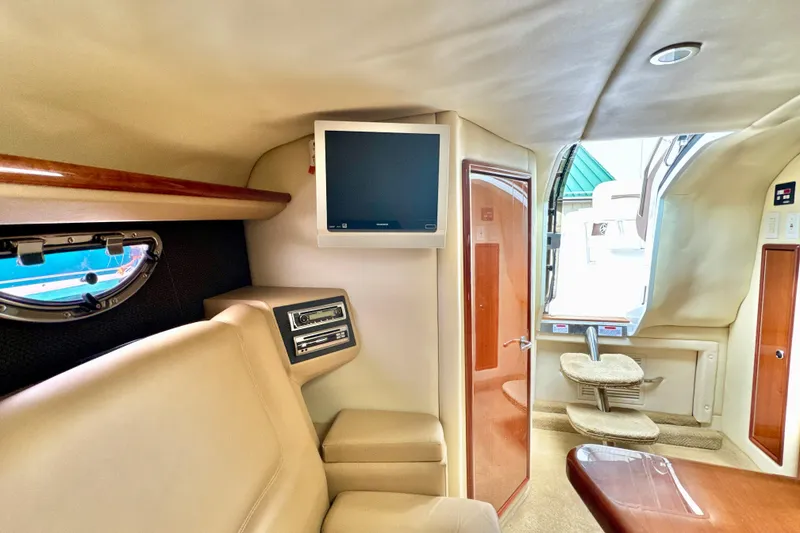 Slide: The Image of Interior of a 2008 Cobalt 323 boat with TV and seating area. - 22