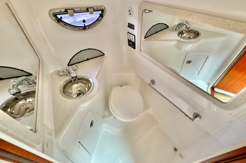 Slide: The Image of Compact bathroom in 2008 Cobalt 323 boat with sink, toilet, and mirror. - 23