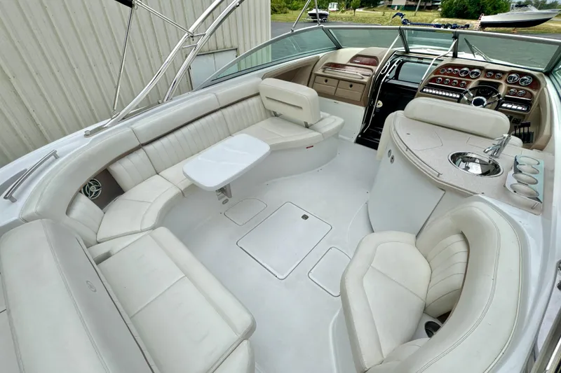 Slide: The Image of 2008 Cobalt 323 boat interior with white seating, table, and dashboard controls. - 8
