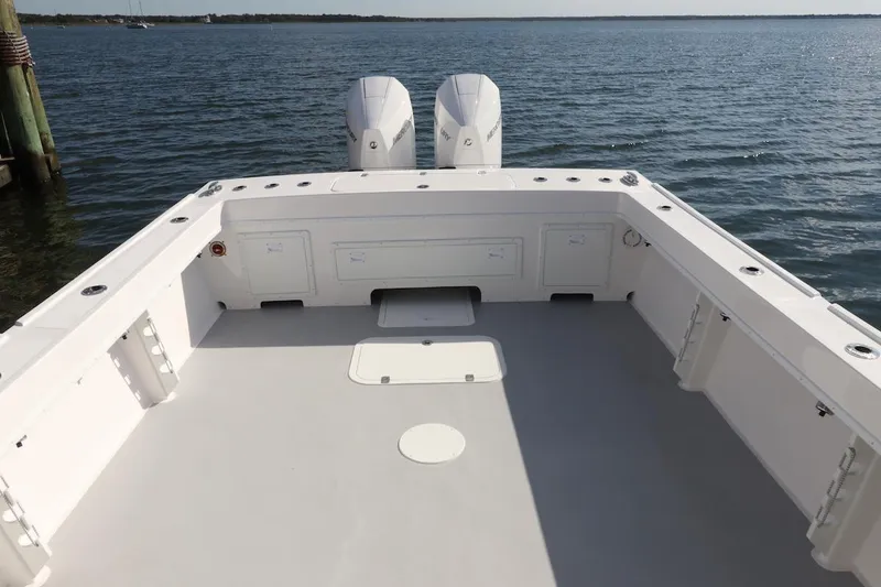 Slide: The Image of Steiger Craft 31 Fisherman 2026 boat deck with twin engines on calm water. - 13