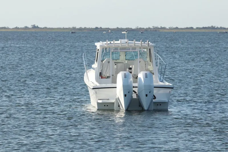 Slide: The Image of 2026 Steiger Craft 31 Fisherman boat with dual engines on open water. - 3