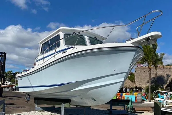 Slide: The Image of 2026 Steiger Craft 28 Miami boat on display under a clear blue sky. - 10