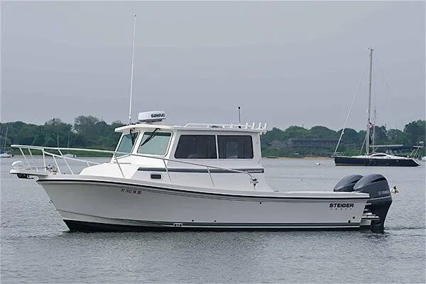 Slide: The Image of 2026 Steiger Craft 28 Miami boat on calm water, side view. - 11