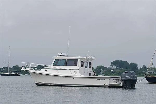 Slide: The Image of 2026 Steiger Craft 28 Miami boat on calm water, overcast sky. - 14